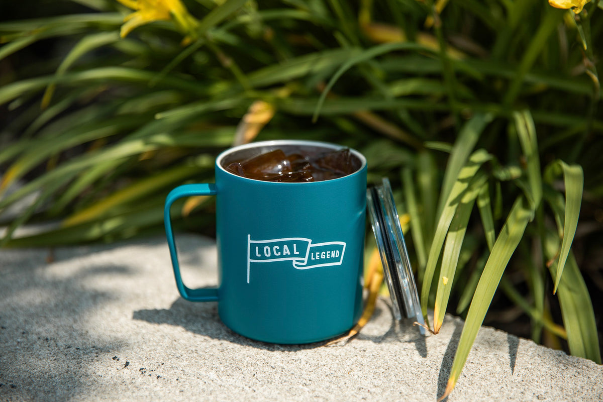 Teal Foster Local Legend mug filled with iced coffee